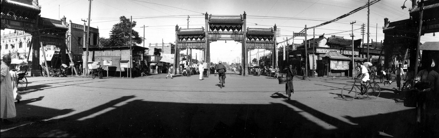 This is a general view showing three of the four gilded gateways at this busy intersection in Peking, China, on June 17, 1935. (AP Photo)