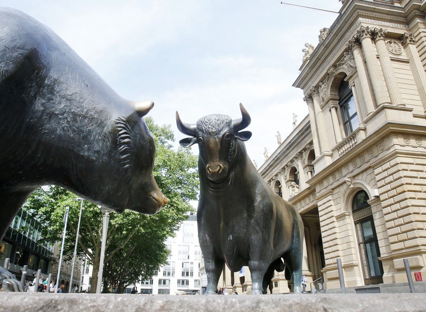 A bronze bull and a bear stand in front of the stock market in Frankfurt, Germany, Monday, June 29, 2015. The stock market lost around 500 points right after its opening. (AP Photo/Michael Probst)