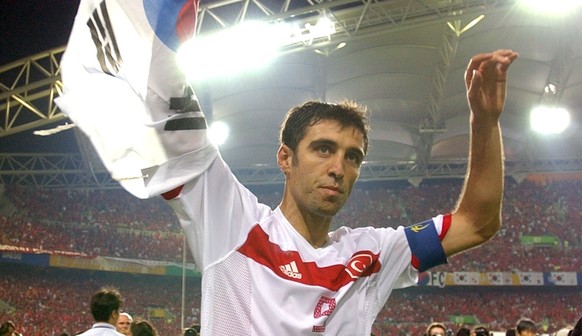 FILE - In this Saturday, June 29, 2002, file photo, Turkey&#039;s Hakan Sukur holds a South Korean flag at the end of the 2002 World Cup third place playoff soccer match between South Korea and Turkey ...