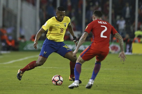 Ecuador&#039;s Antonio Valencia, left, fights for the ball against Chile&#039;s Eugenio Mena during a 2018 World Cup qualifying soccer match in Santiago, Chile, Thursday, Oct. 5, 2017. (AP Photo/Esteb ...