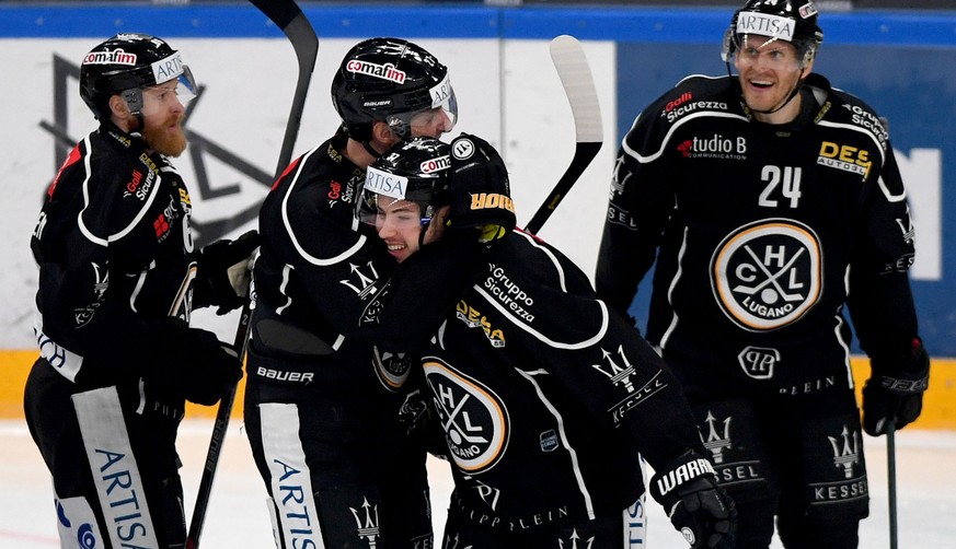 Lugano?s player Elia Riva, center, celebrates the 3-0 goal with team mate, during the preliminary round game of National League A (NLA) Swiss Championship 2019/20 between HC Lugano and ZSC Lions at th ...