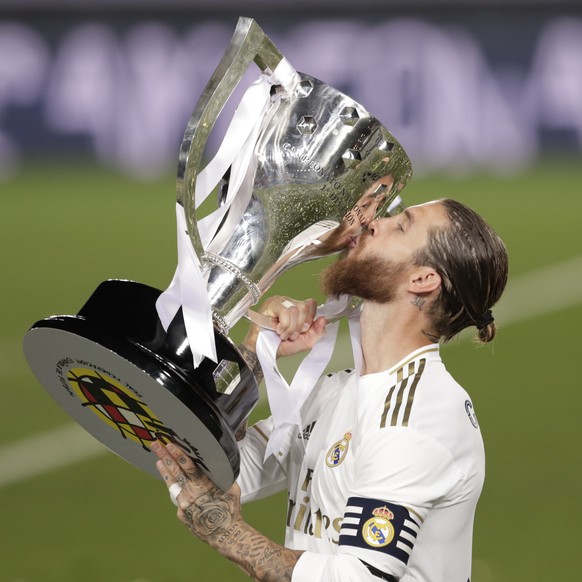 Real Madrid&#039;s captain Sergio Ramos kisses the trophy as he celebrates after winning the Spanish La Liga 2019-2020 following a soccer match between Real Madrid and Villareal at the Alfredo di Stef ...