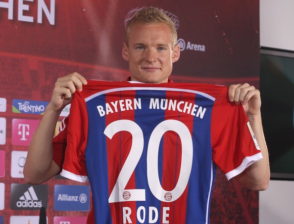 MUNICH, GERMANY - JULY 09: New FC Bayern Muenchen player Sebastian Rode holds up his new jersey during his presentation to the media at the Bayern Muenchen training ground on July 9, 2014 in Munich, G ...