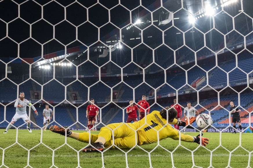 Switzerland&#039;s goalkeeper Yann Sommer, front, blocks a penalty shot by Spain�s Sergio Ramos, left, fights for the ball against $, during the UEFA Nations League group 4 soccer match between Switze ...