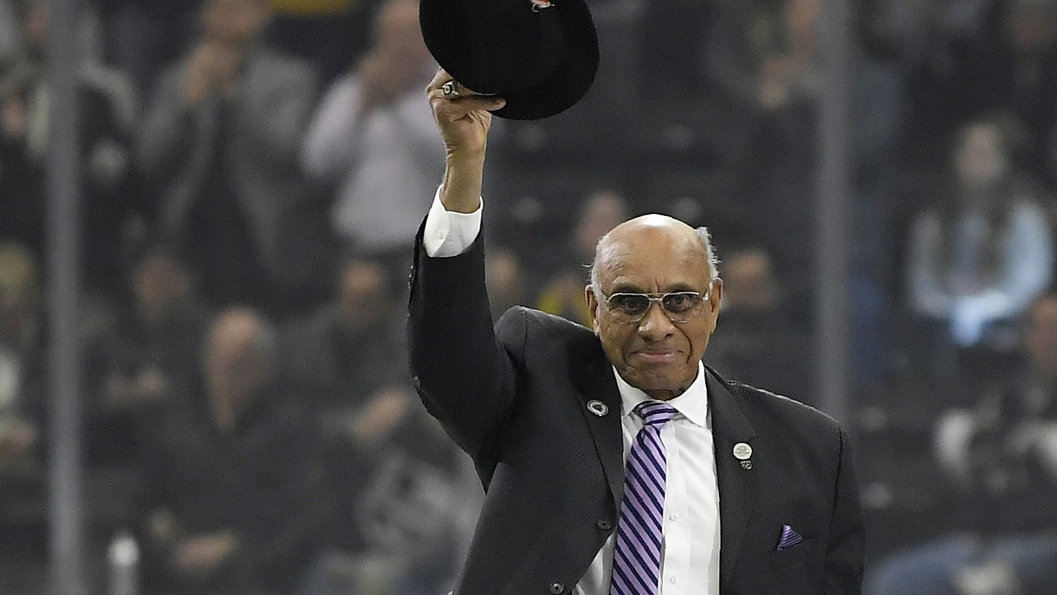 FILE - In this Feb. 22, 2018, file photo, former hockey player Willie O&#039;Ree waves to the crowd after being honored prior to an NHL hockey game between the Los Angeles Kings and the Dallas Stars,  ...