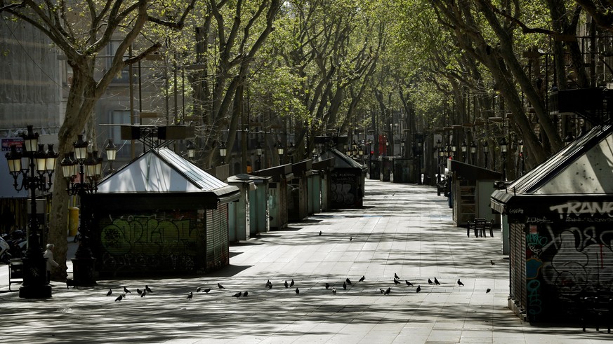 epa08330172 View of Rambla street empty in Barcelona, Spain on 29 March 2020. Spain faces the 15th consecutive day of national lockdown in an effort to slow down the spread of the pandemic COVID-19 di ...
