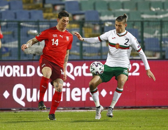 Bulgaria&#039;s Strahil Popov, right, challenges Switzerland&#039;s Steven Zuber, during the World Cup 2022 group C qualifying soccer match between Bulgaria and Switzerland at Vassil Levski stadium, i ...
