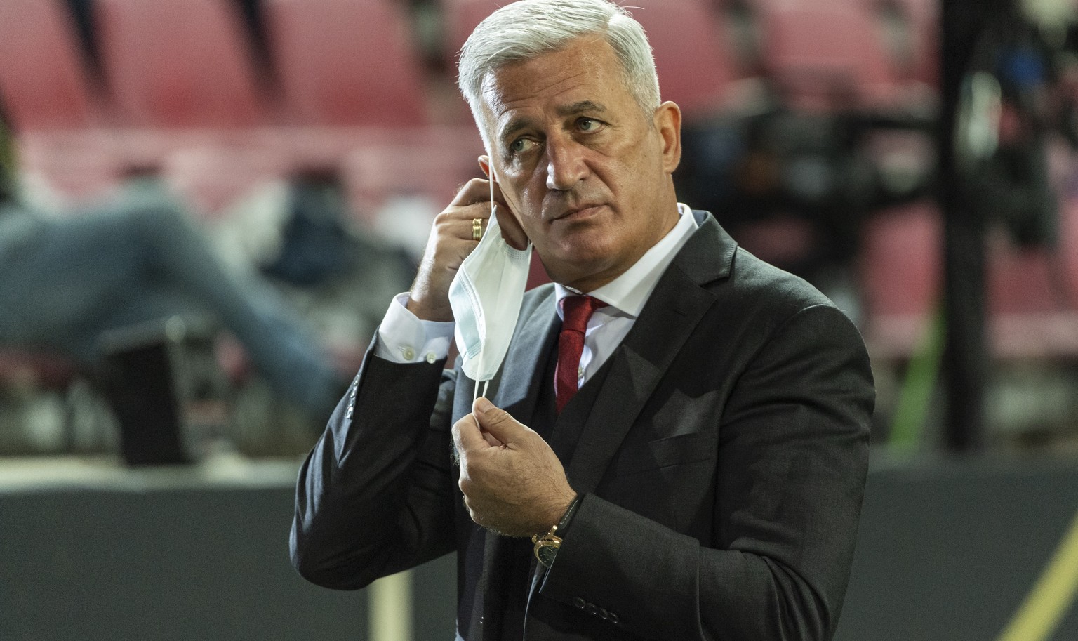Switzerland&#039;s head coach Vladimir Petkovic takes off his face mask to give a TV interview ahead of the UEFA Nations League group 4 soccer match between Germany and Switzerland at the Rhein Energi ...