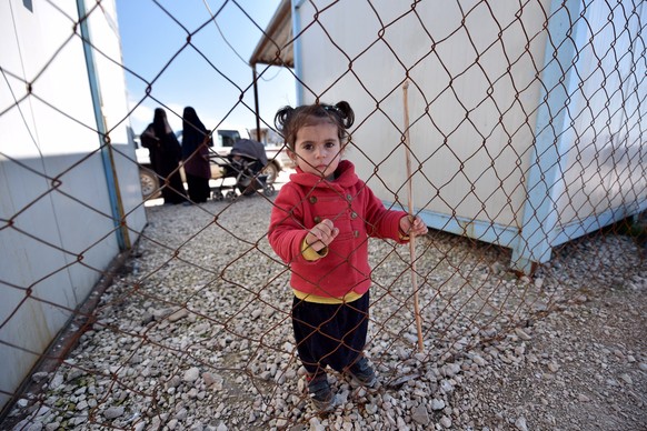 epa07393588 A displaced child poses for a photo at Roj refugees camp in Hasakah, northeast of Syria, 24 February 2019. The camp which is controlled by the US-backed Syrian Democratic Forces (SDF) hous ...