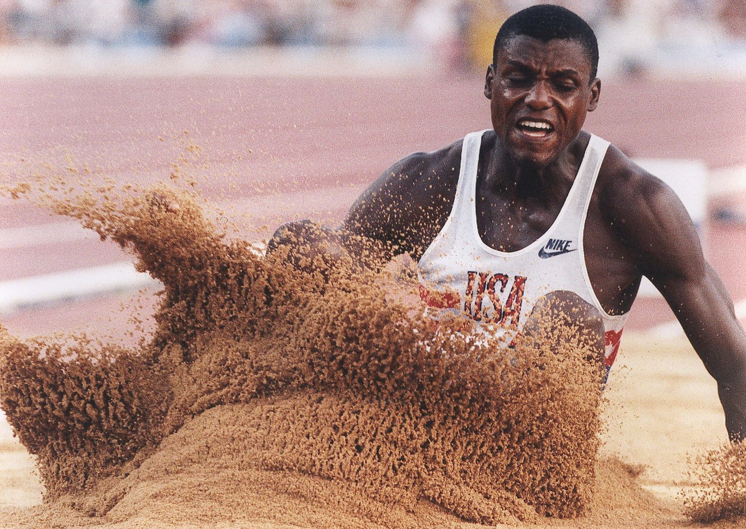 USA&#039;s Carl Lewis hits the sand on his fifth jump during the long jump competition at the Summer Olympics in Barcelona Thursday, Aug. 6, 1992. Lewis won the gold medal in the event. (AP Photo/Eric ...