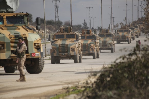 FILE - This Saturday, Feb. 22, 2020 file photo, a Turkish military convoy moves in Idlib province, Syria. A summit meeting between the Turkish and Russian leaders scheduled for Thursday, March 5, 2020 ...