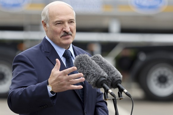 Belarusian President Alexander Lukashenko gestures while addressing employees of the Orsha dairy plant in Orsha, Belarus, Friday, Aug. 28, 2020. (Sergei Shelega, BelTA Pool via AP)