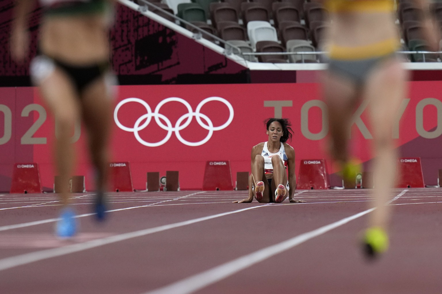 Katarina Johnson-Thompson, of Britain, reacts after dropping to the track during a heat in the heptathlon women&#039;s 200-meter at the 2020 Summer Olympics, Wednesday, Aug. 4, 2021, in Tokyo. (AP Pho ...