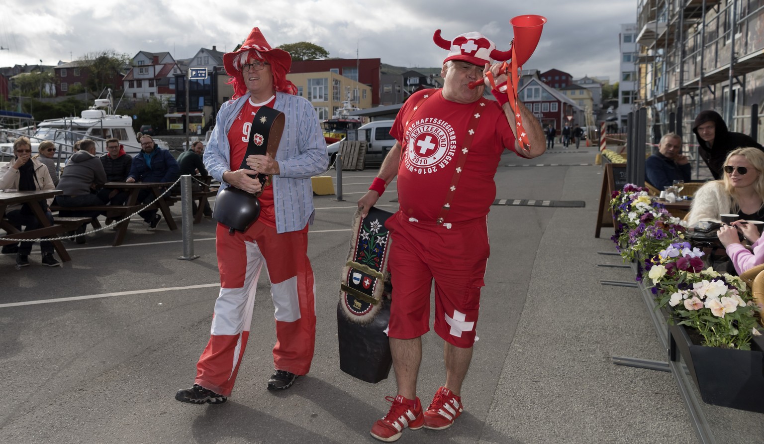 Tow Swiss fans with cowbells parade through Torshavn, Faroe Islands, on Thursday, June 8, 2017. Switzerland is scheduled to play a 2018 Fifa World Cup Russia group B qualification soccer match against ...