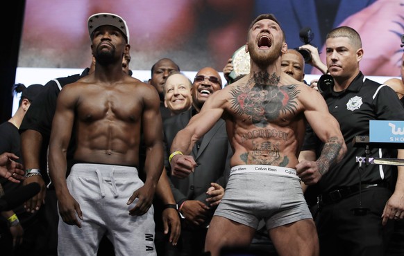 Floyd Mayweather Jr., left, and Conor McGregor pose during weigh-ins Friday, Aug. 25, 2017, in Las Vegas for their Saturday boxing bout. (AP Photo/John Locher)