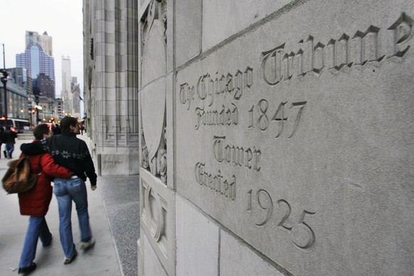 FILE - In this March 30, 2007, file photo, a couple walks past the front entrance to the Tribune Tower, which houses The Chicago Tribune, in Chicago. Tribune Publishing Co., the company that owns the  ...
