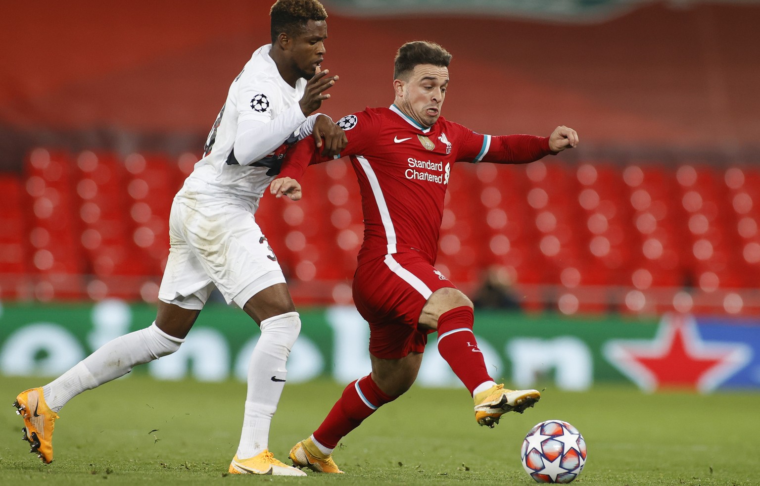 Liverpool&#039;s Xherdan Shaqiri, right, and Midtjylland&#039;s Frank Onyeka vie for the ball during the Champions League Group D soccer match between Liverpool and FC Midtjylland at Anfield stadium,  ...