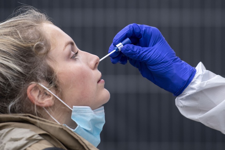 A woman gets a nasal swab at the corona test center at Central Station in Cologne, Germany, Friday, Oct. 23, 2020. According to the Robert Koch Institute, Germany&#039;s federal government agency and  ...