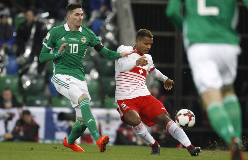 Northern Ireland&#039;s Kyle Lafferty, left, challenges Switzerland&#039;s Manuel Akanji during the World Cup qualifying play-off first leg soccer match between Northern Ireland and Switzerland at Win ...