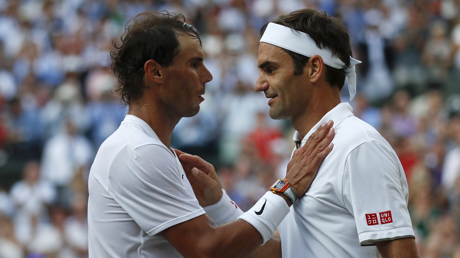 Switzerland&#039;s Roger Federer, right, greets Spain&#039;s Rafael Nadal after beating him in a Men&#039;s singles semifinal match on day eleven of the Wimbledon Tennis Championships in London, Frida ...