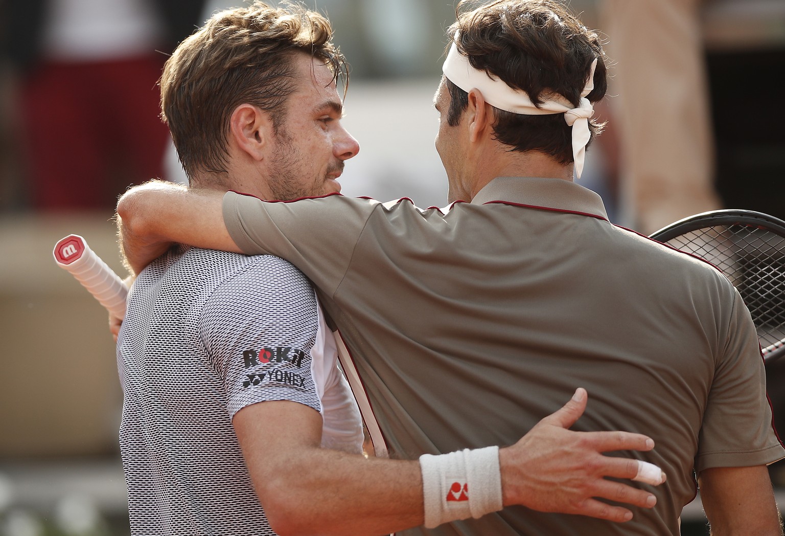 epa07625502 Roger Federer of Switzerland (R) reacts with Stan Wawrinka of Switzerland after winning their men’s quarter final match during the French Open tennis tournament at Roland Garros in Paris,  ...