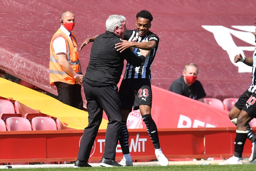 epa09156745 Joseph Willock (R) celebrates with Newcastle manager Steve Bruce after scoring a goal during the English Premier League soccer match between Liverpool FC and Newcastle United in Liverpool, ...