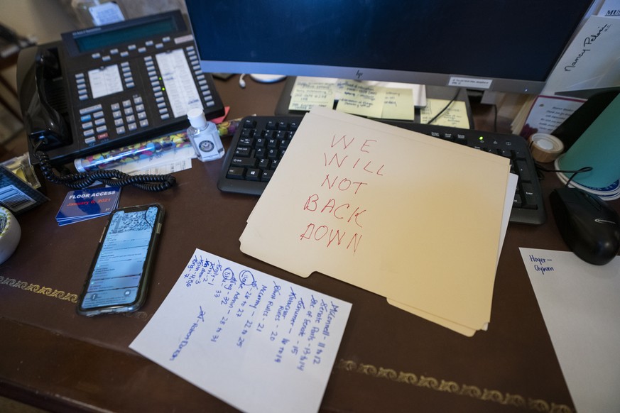 epa08923438 A view of a note left by a supporter of US President Donald J. Trump on the desk of US House Speaker Nancy Pelosi, after supporters of US President Donald J. Trump breached the US Capitol  ...