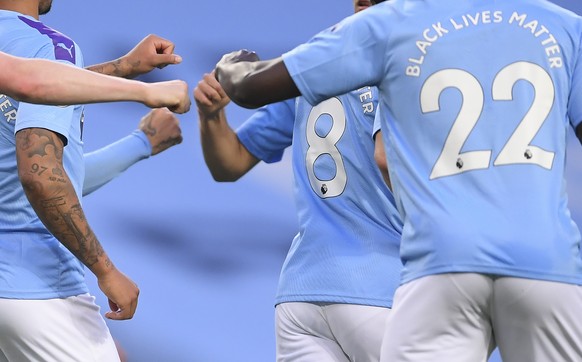 Manchester City players bun fists after Kevin De Bruyne scored the second goal from the penalty spot during the English Premier League soccer match between Manchester City and Arsenal at the Etihad St ...