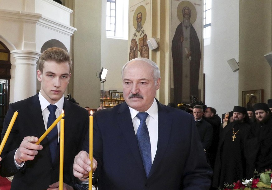 FILE - In this Sunday, April 19, 2020, file photo, Belarusian President Alexander Lukashenko, right, with his son Nikolai, attends the Orthodox Easter service at a church in the village of Malye Lyady ...
