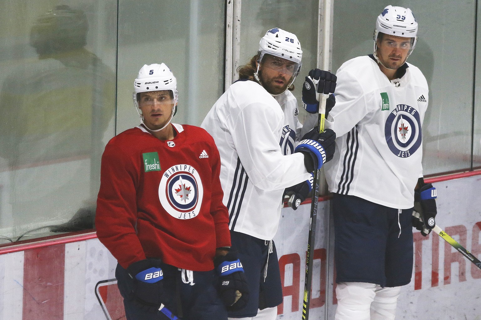 Winnipeg Jets&#039; Luca Sbisa (5), Blake Wheeler (26) and Mark Scheifele (55) look on at practice during their NHL hockey summer training camp as the NHL reopens during COVID-19 in Winnipeg, Tuesday, ...