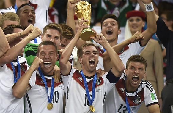 Germany&#039;s Philipp Lahm (16) raises the trophy after the World Cup final soccer match between Germany and Argentina at the Maracana Stadium in Rio de Janeiro, Brazil, Sunday, July 13, 2014. German ...