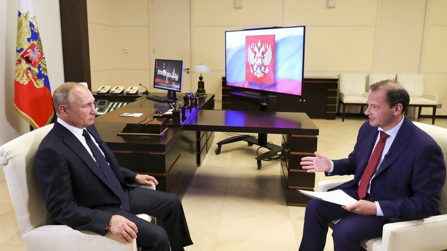 In this photo released by Kremlin Press service via Sputnik on Thursday, Aug. 27, 2020, Russian President Vladimir Putin listens for a question during his interview with Russian journalist Deputy Gene ...
