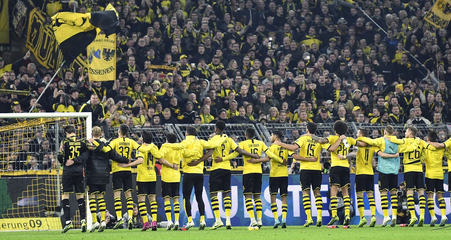 Dortmund&#039;s players celebrates with fans after winning the German Bundesliga soccer match between Borussia Dortmund and Borussia Moenchengladbach in Dortmund, Germany, Saturday Oct. 19, 2019. (AP  ...