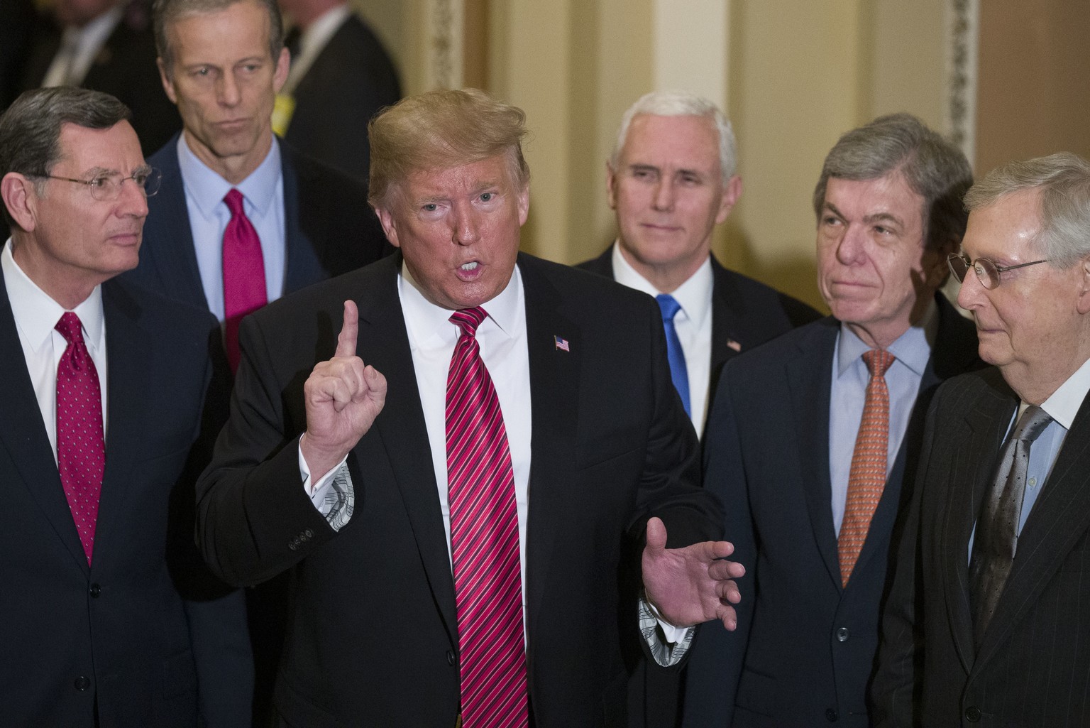 Sen. John Barrasso, R-Wyo., left, and Sen. John Thune, R-S.D., stand with President Donald Trump, Vice President Mike Pence, Sen. Roy Blunt, R-Mo., and Senate Majority Leader Mitch McConnell of Ky., a ...