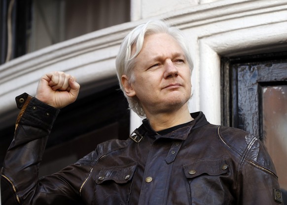 FILE - In this May 19, 2017 file photo, WikiLeaks founder Julian Assange greets supporters outside the Ecuadorian embassy in London, where he has been in self imposed exile since 2012. (AP Photo/Frank ...