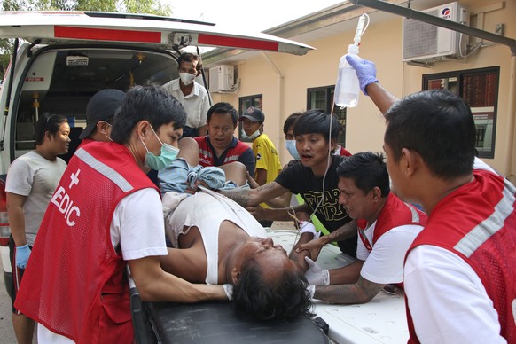An injured anti-coup protester is brought for medical treatment to a hospital in Latha township, Yangon, Myanmar, Saturday, March 27, 2021. As Myanmar���s military celebrated the annual Armed Forces D ...
