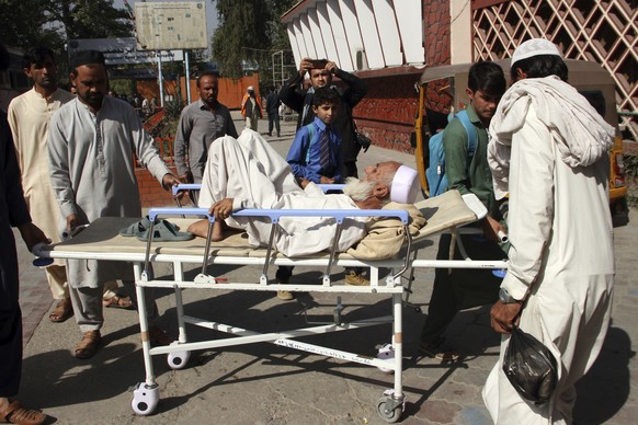 Afghan bring a man injured in a stampede to a hospital in the city of Jalalabad east of Kabul, Afghanistan, Wednesday, Oct. 21, 2020. At least 11 women were trampled to death when a stampede broke out ...