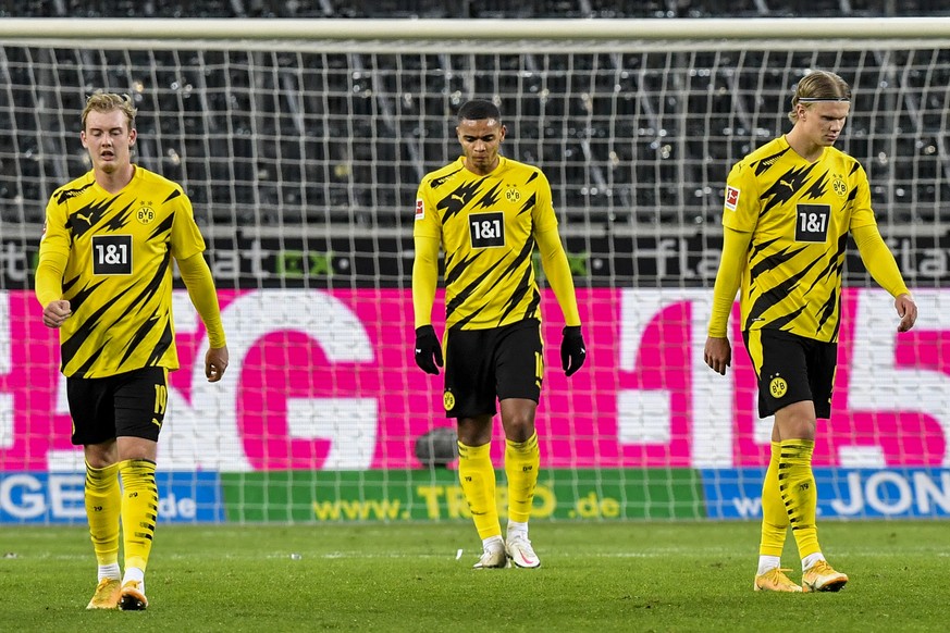 Borussia Dortmund players react after Borussia Moenchengladbach scored the fourth during their German Bundesliga soccer match in Moenchengladbach, Germany, Friday, Jan. 22, 2021. (AP Photo/Martin Meis ...