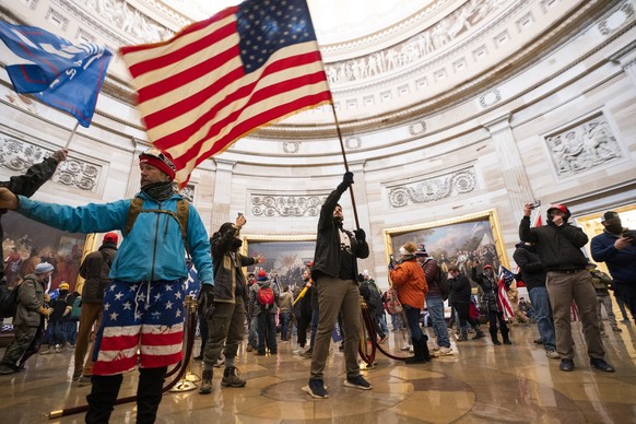 epaselect epa08923424 Supporters of US President Donald J. Trump in the Capitol Rotunda after breaching Capitol security in Washington, DC, USA, 06 January 2021. Protesters entered the US Capitol wher ...