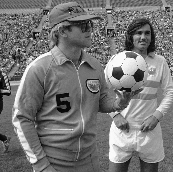 Rock star Elton John, a part owner of the Los Angeles Aztecs of the North American Soccer League, is introduced along with Aztec players at the start of their exhibition with the New York Cosmos in th ...