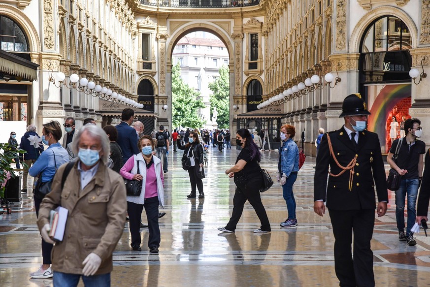 epa08430218 People walking in the Vittorio Emanuele II gallery during phase 2 of the COVID-2 Coronavirus emergency in Milan, Italy, 18 May 2020. Several countries around the globe have started to ease ...