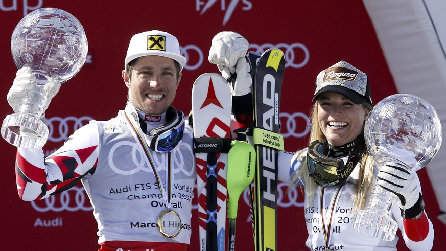 Austria&#039;s Marcel Hirscher, left, and Switzerland&#039;s Lara Gut, respectively winners of the men&#039;s and women&#039;s overall titles, show their crystal globe trophies, at the alpine ski, Wor ...