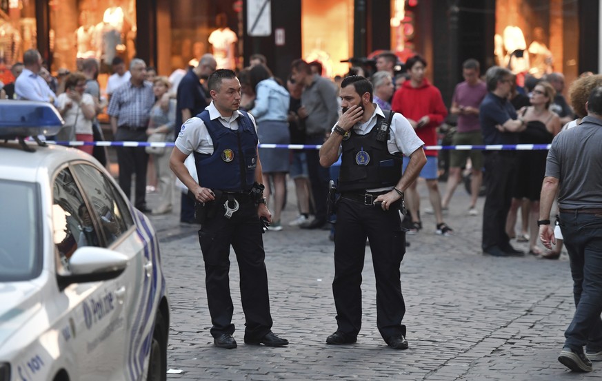 Belgian police stand in front of a police cordon as people are evacuated at the Grand Place square near Central Station in Brussels after a reported explosion on Tuesday, June 20, 2017. Belgian media  ...