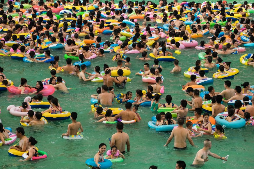 epa06105230 Chinese tourists with swim rings enjoy swimming in the lake called &#039;Dead sea of China&#039; in a resort of Suining city, southwestern China&#039;s Sichuan province, 22 July 2017. More ...