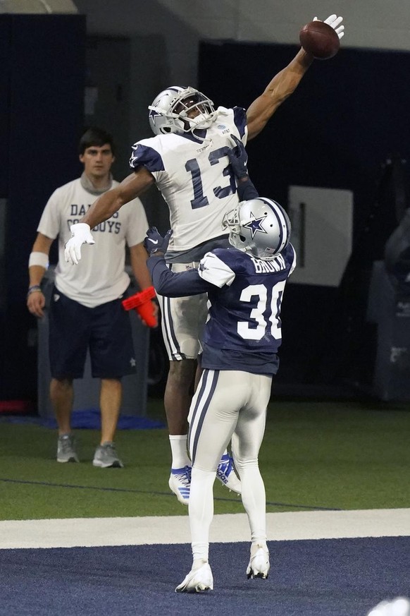 Dallas Cowboys wide receiver Michael Gallup (13) reaches for a successful one handed catch in the end zone against cornerback Anthony Brown (30) during an NFL training camp practice in Frisco, Texas,  ...