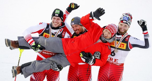 epaselect epa07377382 (L-R) second placed Michael Matt, winner Marcel Hirscher and third placed Marco Schwarz, all of Austria, raise Peter Schroecksnadel (C), President of the Austrian Ski Federation, ...