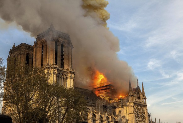 FILE - In this April 15, 2019, file photo, the Notre Dame Cathedral burns in Paris. The cathedral stands crippled, locked in a dangerous web of twisted metal scaffolding one year after a cataclysmic f ...
