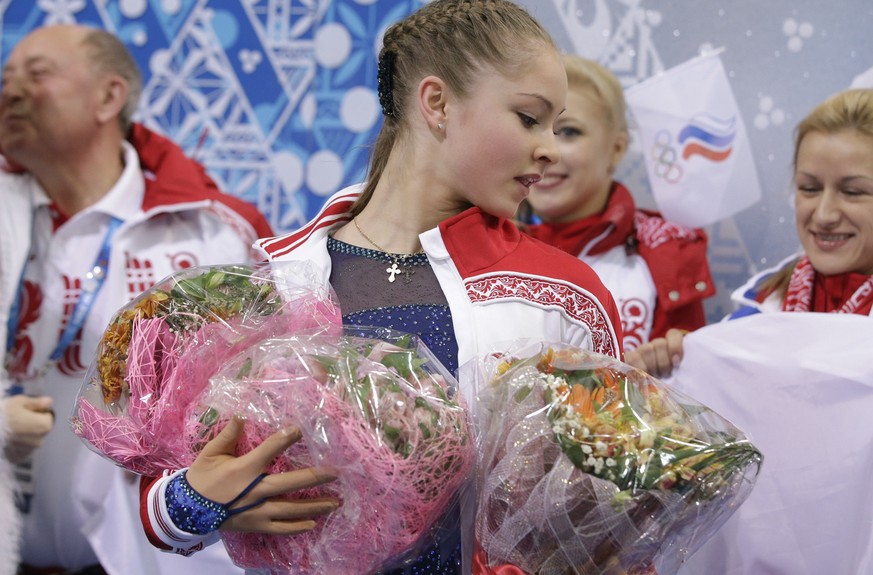 Yulia Lipnitskaya of Russia holds flowers given to her by spectators after competing in the women&#039;s team short program figure skating competition at the Iceberg Skating Palace during the 2014 Win ...