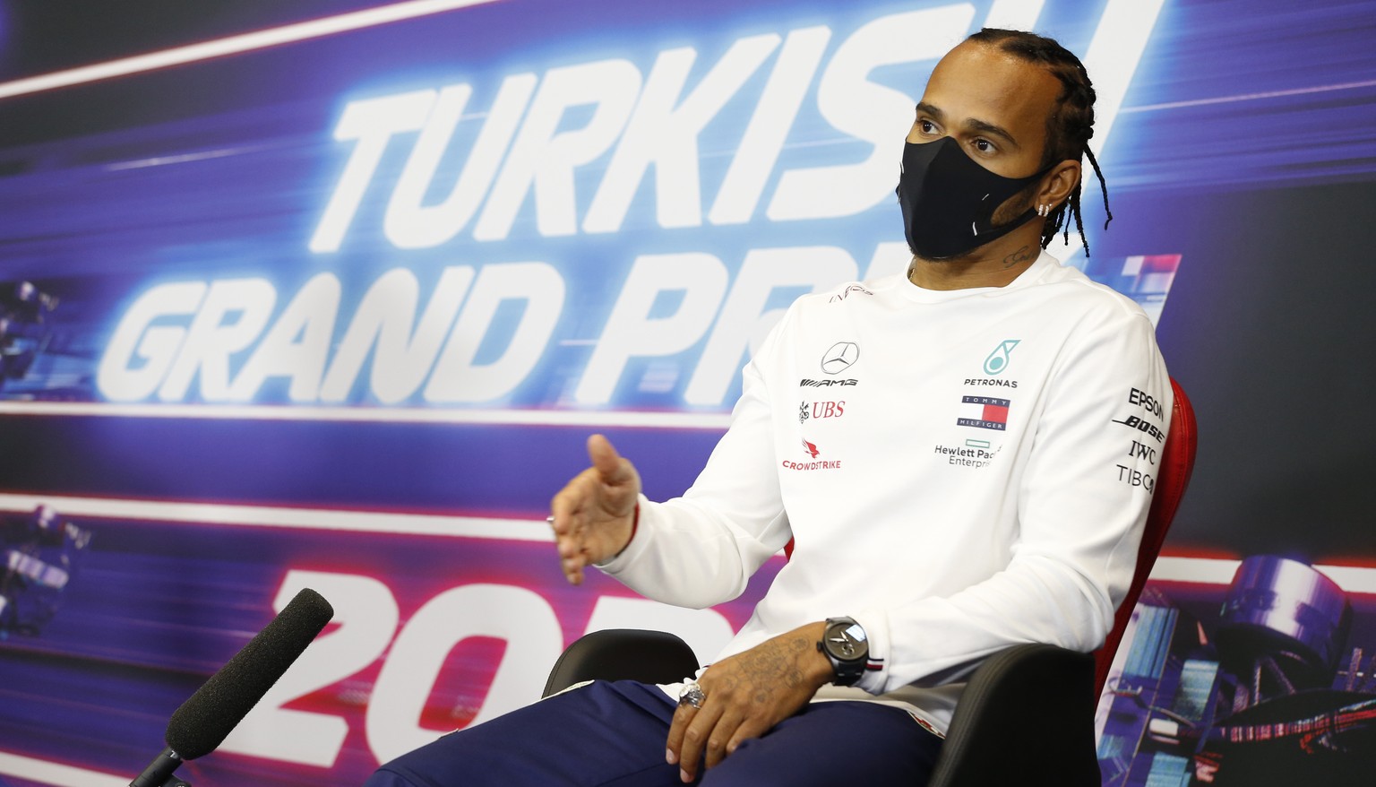 epa08815910 A handout photo made available by the FIA of British Formula One driver Lewis Hamilton of Mercedes-AMG Petronas wearing a protective face mask during a press conference in Istanbul, Turkey ...