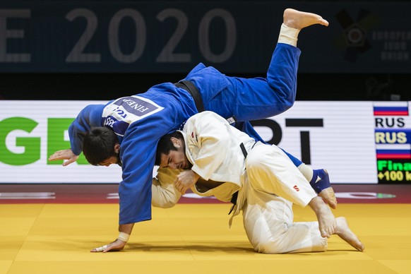 epa08834308 Tamerlan Bashaev of Russia (white) and Inal Tasoev of Russia (blue) in action during the final bout in the men&#039;s +100kg category at the European Judo Championships in Prague, Czech Re ...